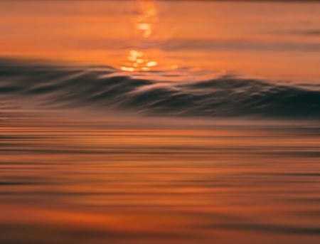 Sunset reflecting on waves in the sea 