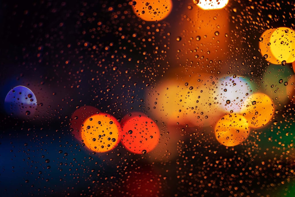 Water droplets on glass with bokeh